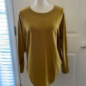 Fashionable accented mustard colored sweater.
